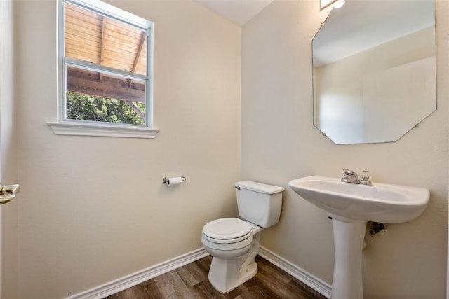 11607 Robert Wooding Dr, Austin, TX 78748 - bathroom featuring baseboards, toilet, and wood finished floors