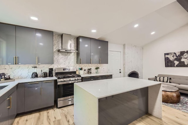 5236 Meadow Creek Dr, Austin, TX 78745 - kitchen featuring stainless steel range with gas cooktop, wall chimney exhaust hood, gray cabinets, recessed lighting, and vaulted ceiling