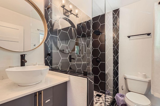 5236 Meadow Creek Dr, Austin, TX 78745 - full bathroom with vanity, a tile shower, and toilet