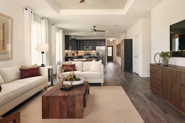 814 Cherrystone Loop, Buda, TX 78610 - living area featuring a ceiling fan, dark wood finished floors, recessed lighting, and a tray ceiling