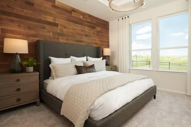 814 Cherrystone Loop, Buda, TX 78610 - bedroom with light carpet, wooden walls, and baseboards