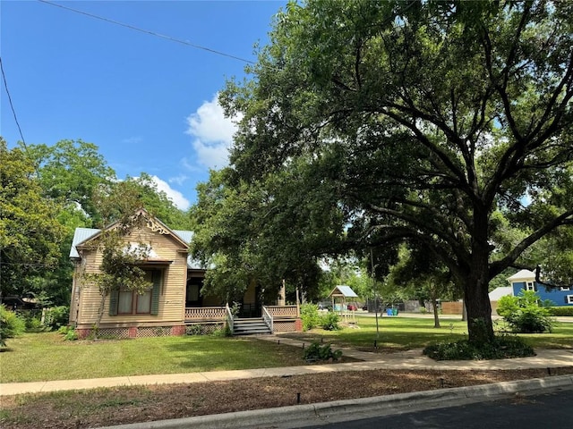 1303 Pecan St, Bastrop, TX 78602 - view of green lawn with covered porch