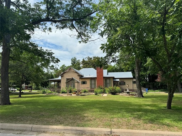 1303 Pecan St, Bastrop, TX 78602 - ranch-style house featuring a front yard and a chimney