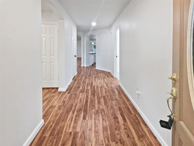 126 Waterlily Way, Hutto, TX 78634 - hall with arched walkways, wood finished floors, and recessed lighting