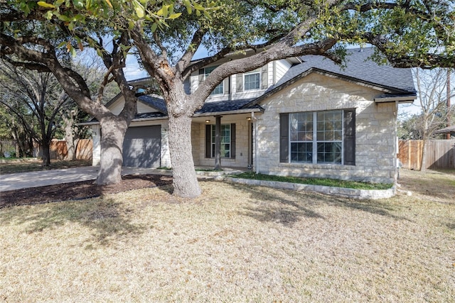 1301 Chardonnay Xing, Leander, TX 78641 - view of front facade with stone siding, roof with shingles, concrete driveway, and a porch