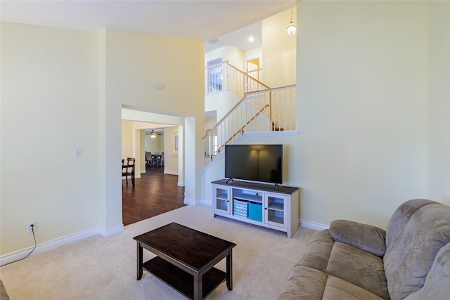 1301 Chardonnay Xing, Leander, TX 78641 - carpeted living area with stairs, baseboards, a high ceiling, and a ceiling fan