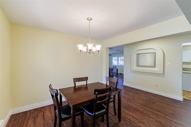 1301 Chardonnay Xing, Leander, TX 78641 - dining room with a chandelier, dark wood-style flooring, and baseboards