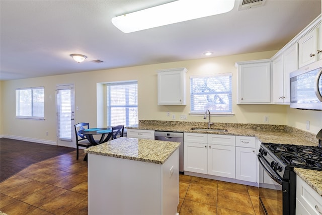 1301 Chardonnay Xing, Leander, TX 78641 - kitchen with a sink, stainless steel appliances, a center island, and white cabinets