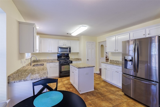 1301 Chardonnay Xing, Leander, TX 78641 - kitchen featuring appliances with stainless steel finishes, a sink, white cabinetry, and light tile patterned floors