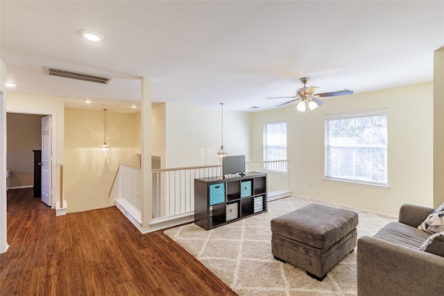 1301 Chardonnay Xing, Leander, TX 78641 - living area with wood finished floors, ceiling fan, and recessed lighting