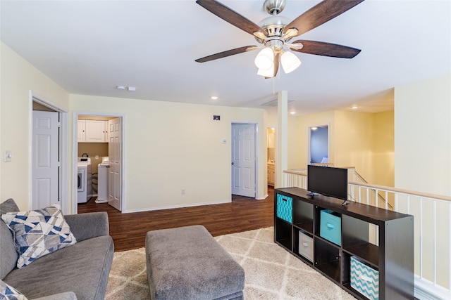 1301 Chardonnay Xing, Leander, TX 78641 - living area with wood finished floors, a ceiling fan, washer / clothes dryer, baseboards, and recessed lighting