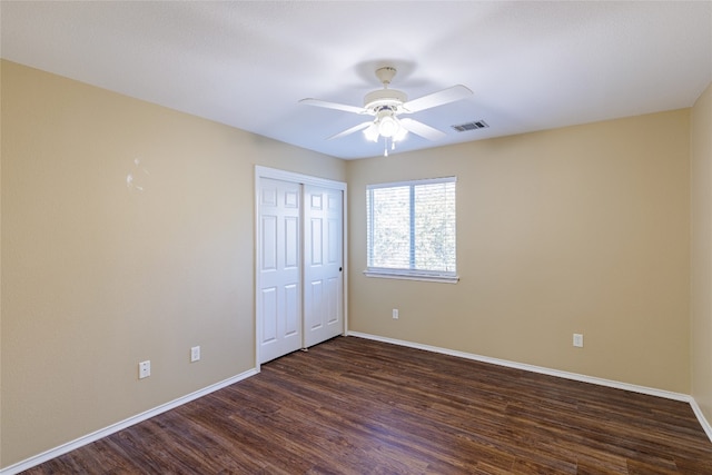 1301 Chardonnay Xing, Leander, TX 78641 - unfurnished bedroom featuring baseboards, dark wood-type flooring, ceiling fan, and a closet