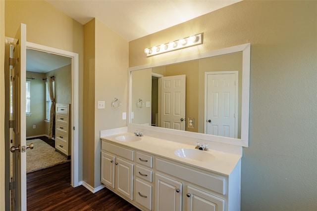 1301 Chardonnay Xing, Leander, TX 78641 - full bathroom with double vanity, wood finished floors, and baseboards