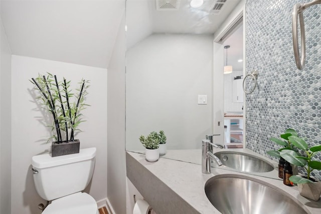 2001 Whitebead Trl, Austin, TX 78734 - half bath with toilet, decorative backsplash, vaulted ceiling, and vanity