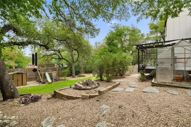 2001 Whitebead Trl, Austin, TX 78734 - view of yard featuring an exterior structure, an outdoor structure, a playground, and a fire pit