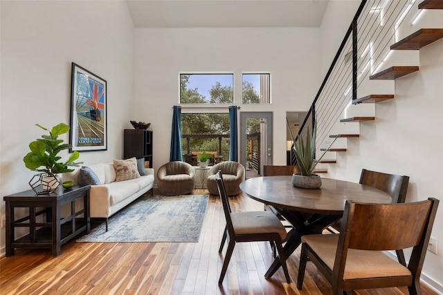 2001 Whitebead Trl, Austin, TX 78734 - dining space with stairs, a towering ceiling, and light wood-style floors
