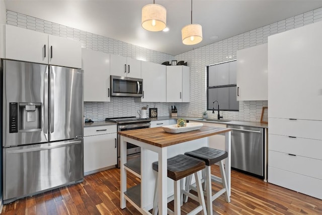 2001 Whitebead Trl, Austin, TX 78734 - kitchen with appliances with stainless steel finishes, a sink, wood counters, and white cabinetry