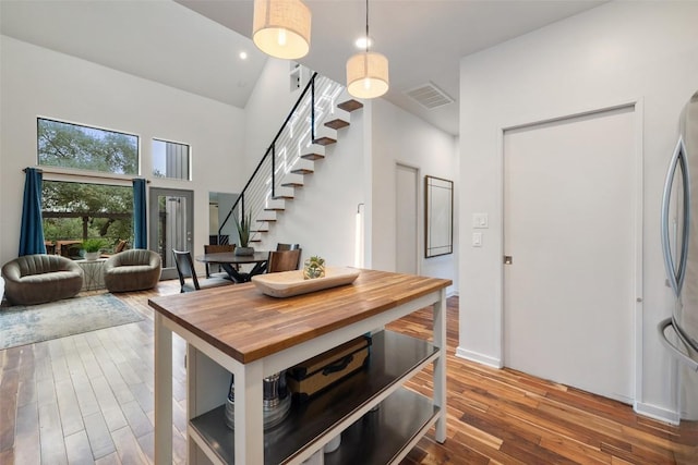 2001 Whitebead Trl, Austin, TX 78734 - dining area with stairway, hardwood / wood-style flooring, and a high ceiling