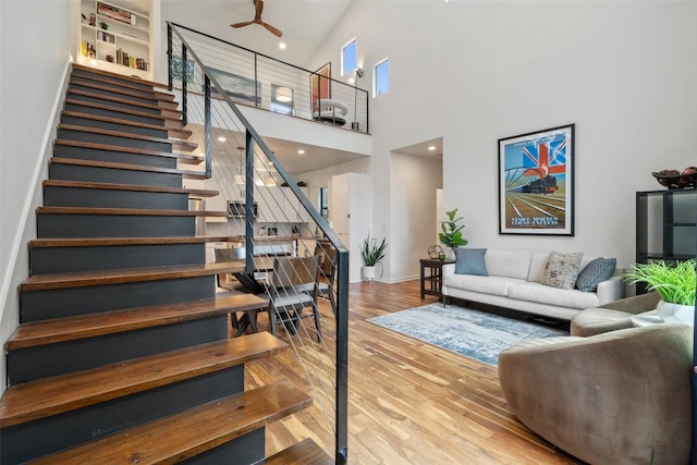 2001 Whitebead Trl, Austin, TX 78734 - stairs featuring a high ceiling, wood finished floors, baseboards, a ceiling fan, and recessed lighting