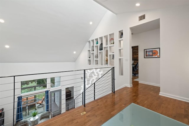 2001 Whitebead Trl, Austin, TX 78734 - hall with an upstairs landing, high vaulted ceiling, wood finished floors, recessed lighting, and baseboards