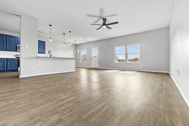 223 Hunters Brk, San Antonio, TX 78253 - unfurnished living room featuring ceiling fan, dark wood-style floors, and baseboards