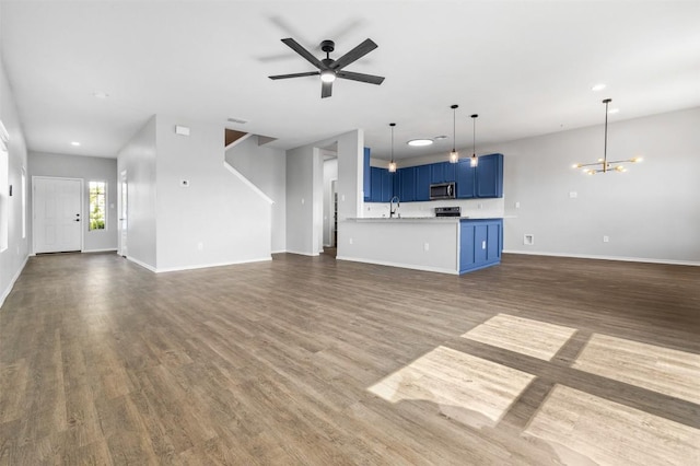 223 Hunters Brk, San Antonio, TX 78253 - unfurnished living room with a chandelier, dark wood-style flooring, baseboards, a ceiling fan, and recessed lighting