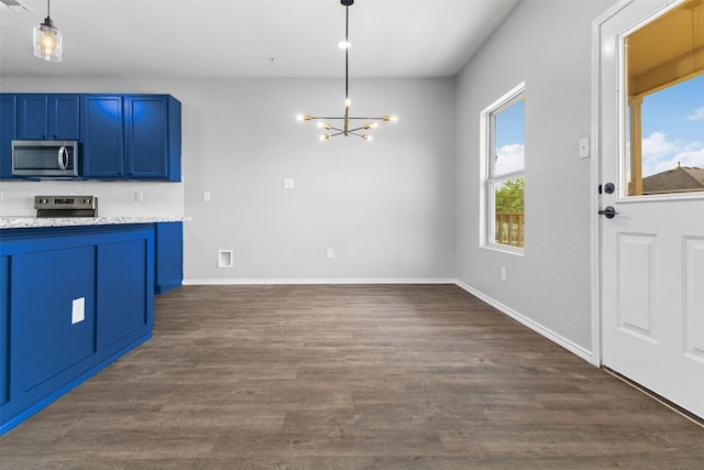 223 Hunters Brk, San Antonio, TX 78253 - kitchen with stainless steel microwave, range, a chandelier, blue cabinets, and dark wood-type flooring