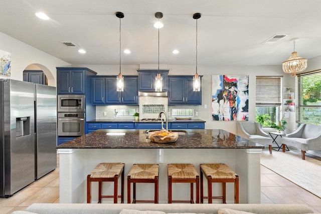 601 Harris Dr, Austin, TX 78737 - kitchen with appliances with stainless steel finishes, blue cabinets, a kitchen breakfast bar, a sink, and recessed lighting