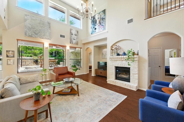 601 Harris Dr, Austin, TX 78737 - living area featuring arched walkways, plenty of natural light, dark wood-style floors, and a towering ceiling
