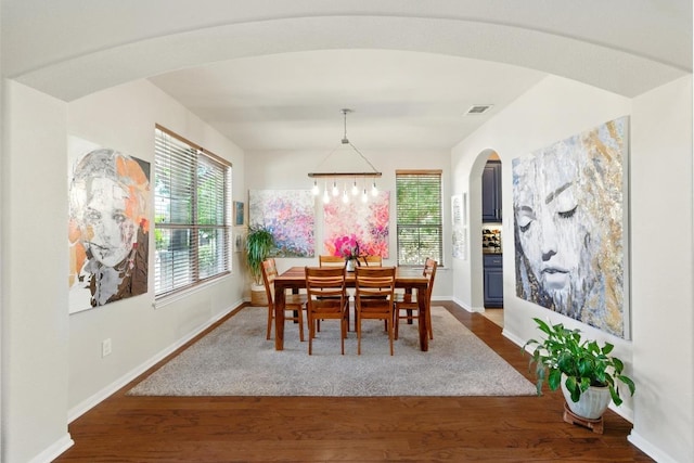 601 Harris Dr, Austin, TX 78737 - dining space with arched walkways, baseboards, and wood finished floors