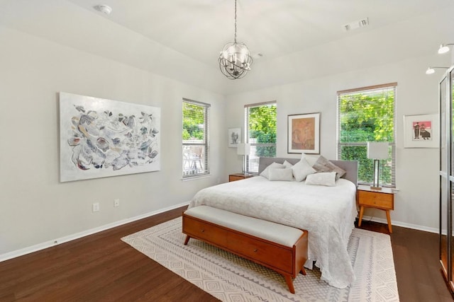 601 Harris Dr, Austin, TX 78737 - bedroom with a chandelier, wood finished floors, and baseboards