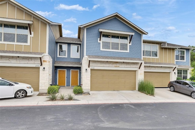 516 E Slaughter Ln Unit 2303, Austin, TX 78744 - view of property with stone siding, concrete driveway, board and batten siding, and an attached garage