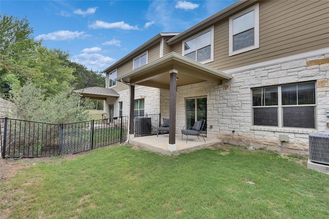 516 E Slaughter Ln Unit 2303, Austin, TX 78744 - back of house with stone siding, a patio area, and cooling unit