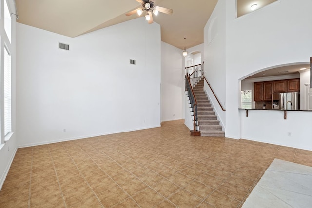 16304 Fincastle Dr, Austin, TX 78717 - unfurnished living room with high vaulted ceiling, a ceiling fan, stairs, and light tile patterned flooring