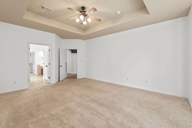 16304 Fincastle Dr, Austin, TX 78717 - unfurnished bedroom featuring a raised ceiling, light colored carpet, baseboards, ensuite bath, and a ceiling fan