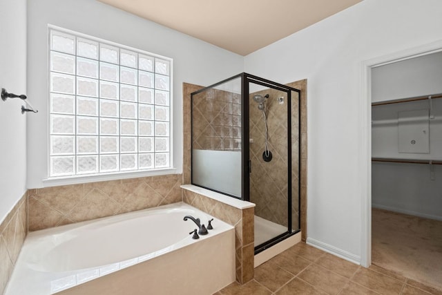 16304 Fincastle Dr, Austin, TX 78717 - bathroom featuring a bath, a stall shower, tile patterned flooring, and a spacious closet