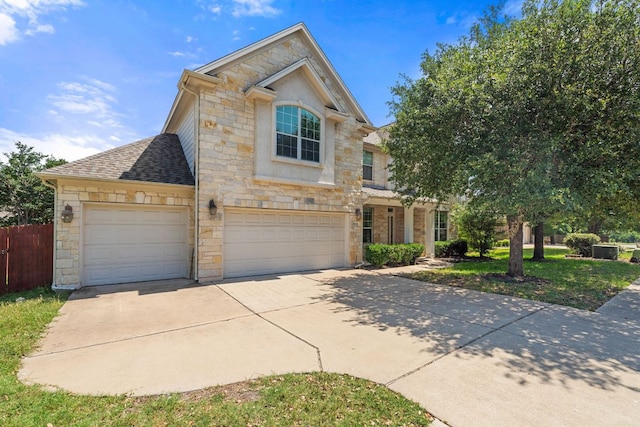 16304 Fincastle Dr, Austin, TX 78717 - view of front of home featuring stone siding, concrete driveway, and roof with shingles