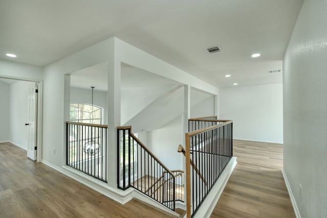2106 Lobelia Dr, Cedar Park, TX 78613 - stairs featuring wood finished floors, baseboards, recessed lighting, and a chandelier