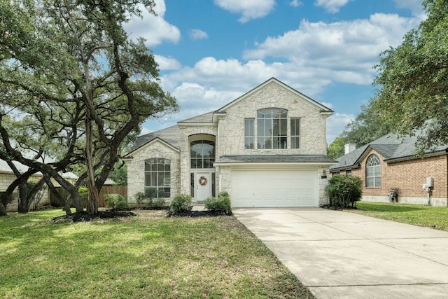 2106 Lobelia Dr, Cedar Park, TX 78613 - french country inspired facade featuring stone siding, a garage, concrete driveway, and a front yard