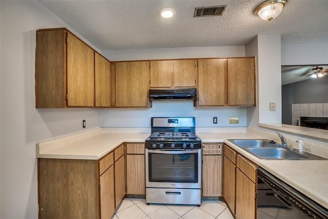 6009 Baton Rouge Dr, Austin, TX 78727 - kitchen with stainless steel gas range oven, black dishwasher, range hood, a sink, and light countertops