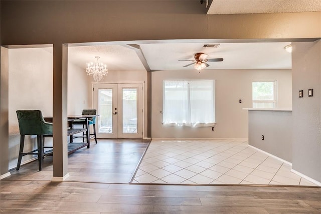 6009 Baton Rouge Dr, Austin, TX 78727 - foyer with wood finished floors, a ceiling fan, french doors, baseboards, and a chandelier