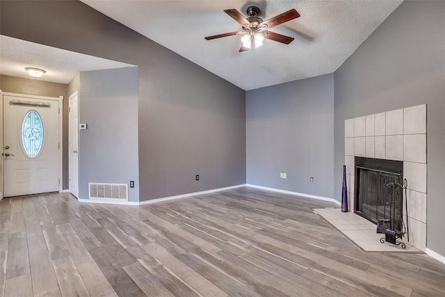 6009 Baton Rouge Dr, Austin, TX 78727 - unfurnished living room featuring vaulted ceiling, ceiling fan, light wood finished floors, a fireplace, and baseboards
