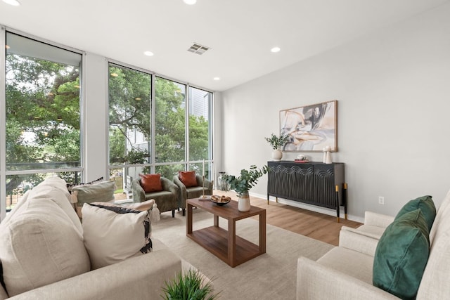 1500 Summit St Unit 4, Austin, TX 78741 - living room with expansive windows, wood finished floors, recessed lighting, and baseboards