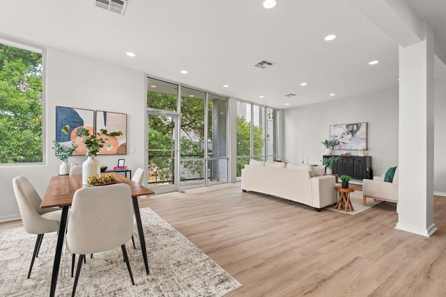 1500 Summit St Unit 4, Austin, TX 78741 - dining space featuring expansive windows, healthy amount of natural light, recessed lighting, light wood finished floors, and baseboards