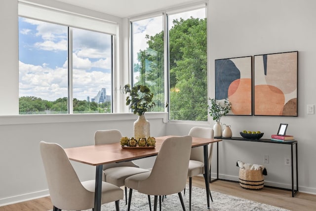 1500 Summit St Unit 4, Austin, TX 78741 - dining space featuring light wood-style flooring and baseboards