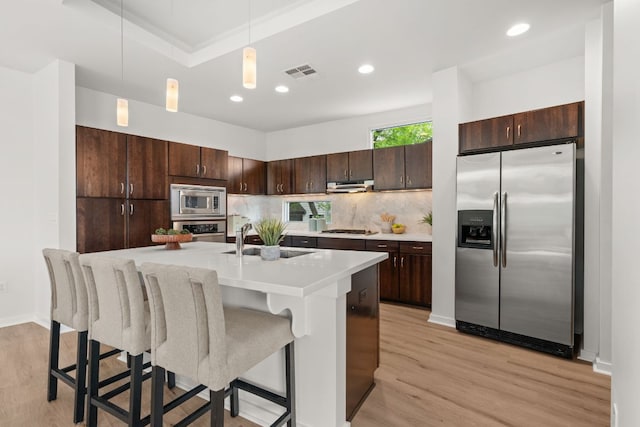 1500 Summit St Unit 4, Austin, TX 78741 - kitchen featuring stainless steel appliances, dark brown cabinetry, a sink, light countertops, and recessed lighting