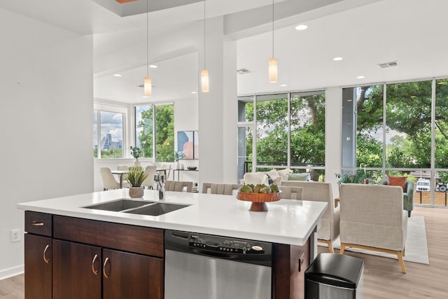 1500 Summit St Unit 4, Austin, TX 78741 - kitchen featuring dishwasher, open floor plan, light wood finished floors, light countertops, and a kitchen island with sink