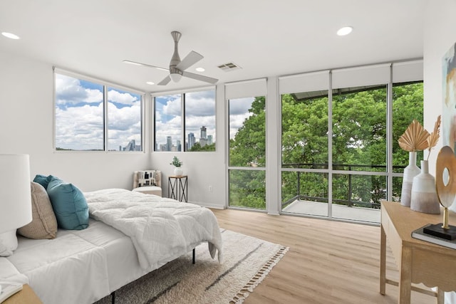 1500 Summit St Unit 4, Austin, TX 78741 - bedroom with multiple windows, light wood-type flooring, recessed lighting, floor to ceiling windows, and ceiling fan