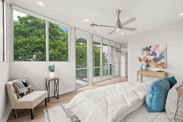 1500 Summit St Unit 4, Austin, TX 78741 - bedroom with multiple windows, wood finished floors, and recessed lighting