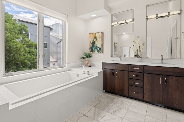 1500 Summit St Unit 4, Austin, TX 78741 - bathroom with double vanity, a garden tub, and marble look tile flooring